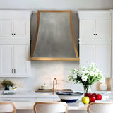 Modern kitchen with white cabinets, a range hood, and decorative elements.